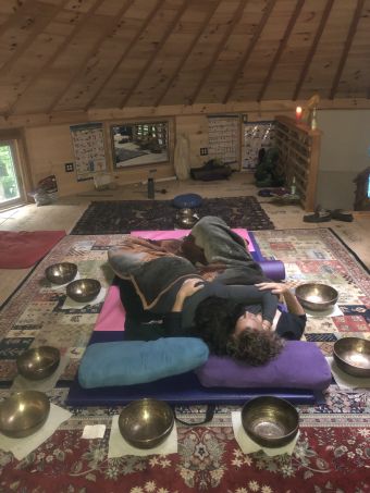y/04 couple embracing, surrounded by singing bowls