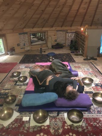 y/15 couple embracing, surrounded by singing bowls