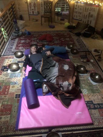 y/19 couple embracing, surrounded by singing bowls