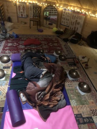 y/35 couple embracing, surrounded by singing bowls