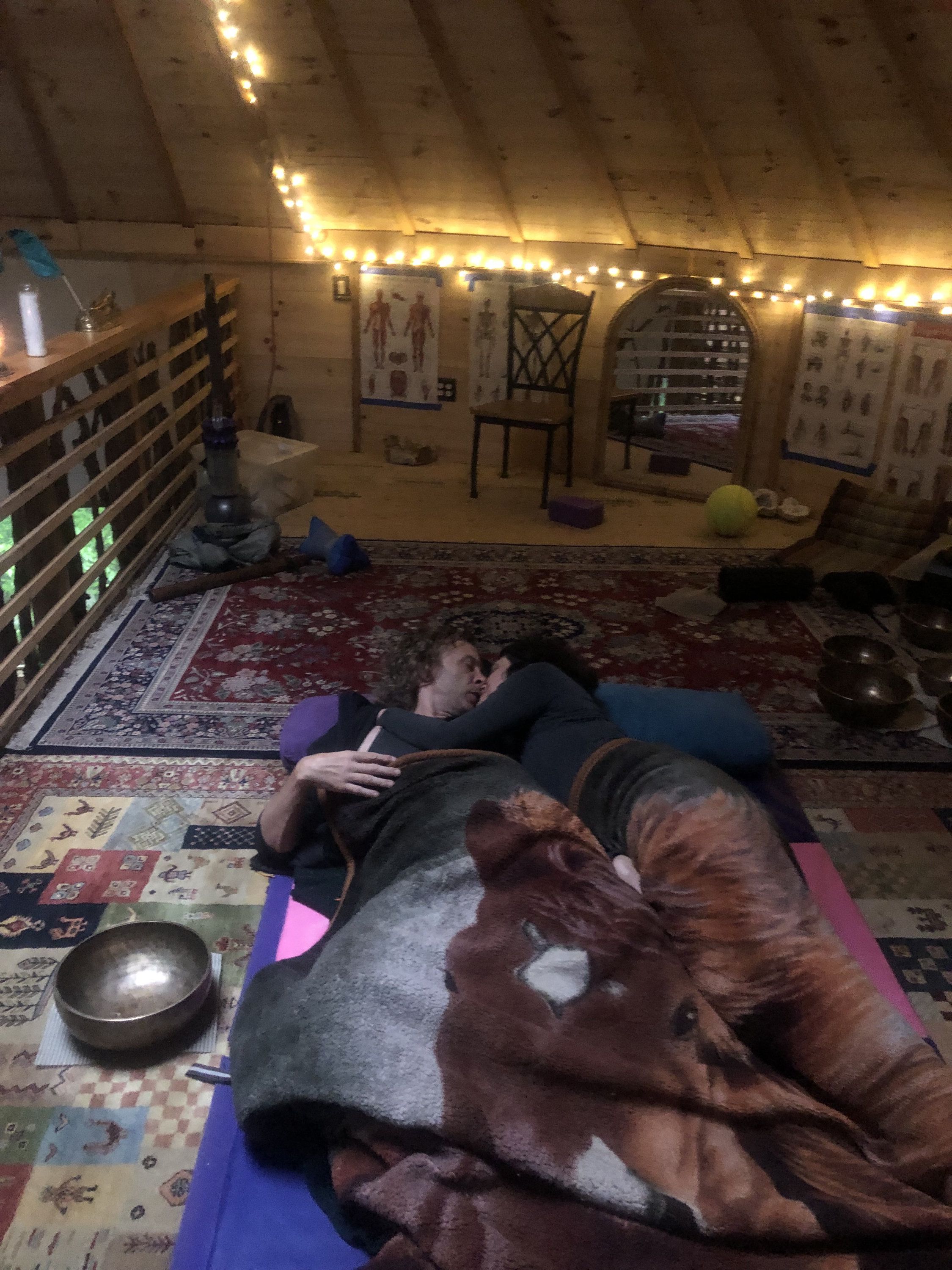 45 couple embracing, surrounded by singing bowls
